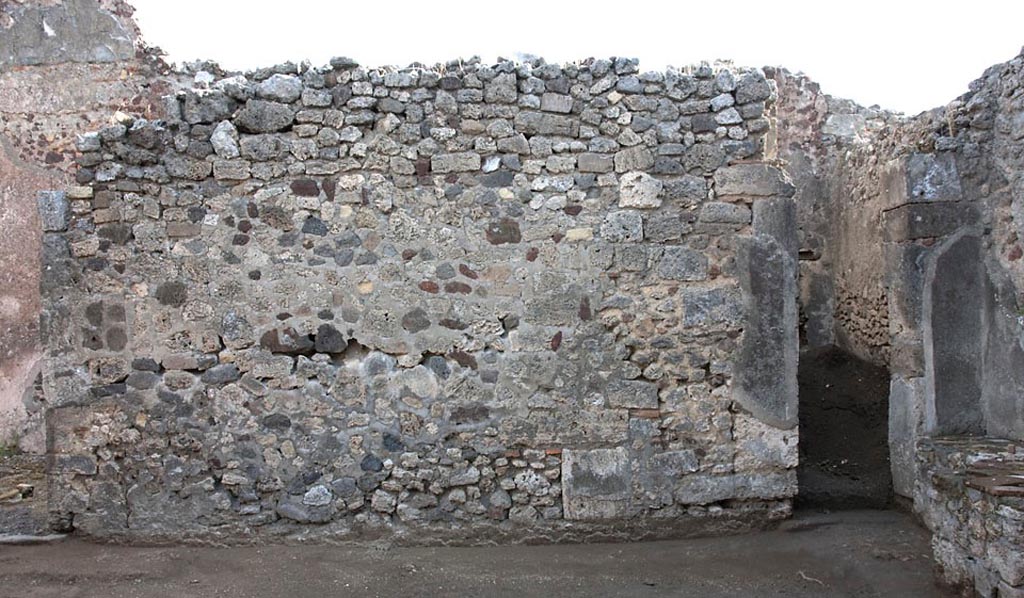 V.1.3 Pompeii. c.2008-10.
Room 2, east wall of atrium, with doorway to corridor 3, (now blocked), in south-east corner. Photo by Hans Thorwid.
Photo courtesy of the Swedish Pompeii Project.