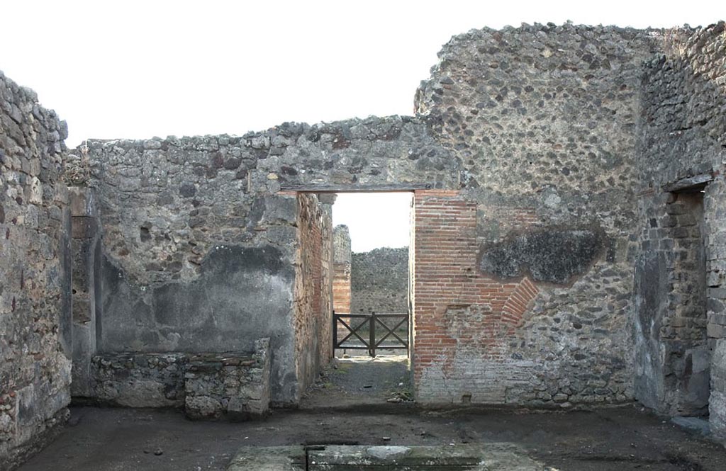 V.1.3 Pompeii. c c.2008-10.
Room 2, south wall of atrium, with hearth on left, and entrance doorway onto Via di Nola, in centre. Photo by Hans Thorwid.
Photo courtesy of the Swedish Pompeii Project.
