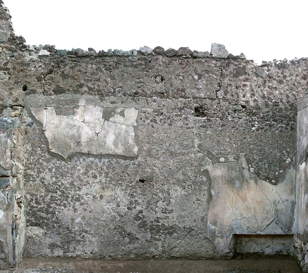 V.1.3 Pompeii. c.2008-10.
Room 4, triclinium, east wall, with niche/recess at south end. Photo by Hans Thorwid.
“Almost the entire niche is covered by plaster.
In the S corner and along the floor there are remains of black bands. Also the upper part has minor traces of black.
There is modern plaster in a small area in the middle of the niche, and to some extent also on the S side.
The N side is covered with modern mortar.”
Photo and words courtesy of the Swedish Pompeii Project.