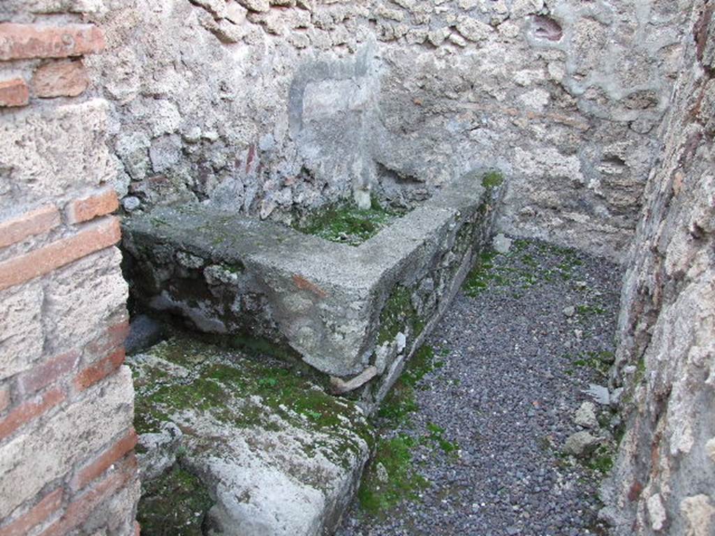 V.1.4 Pompeii. December 2006. Looking north. North west corner of rear room on west side, with base of stairs to upper floor and water basin.