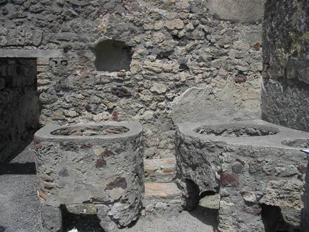 V.1.5 Pompeii. May 2003. Door to rear room in north wall with niche, and boilers or kettles nearby. Photo courtesy of Nicolas Monteix.