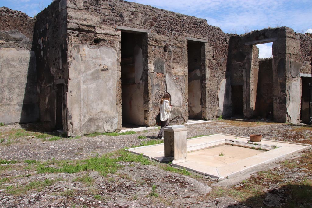 V.1.7 Pompeii. May 2024.
Looking south-east across impluvium towards rooms 9, 8, 7, 6 and 5, on east side of atrium. Photo courtesy of Klaus Heese.