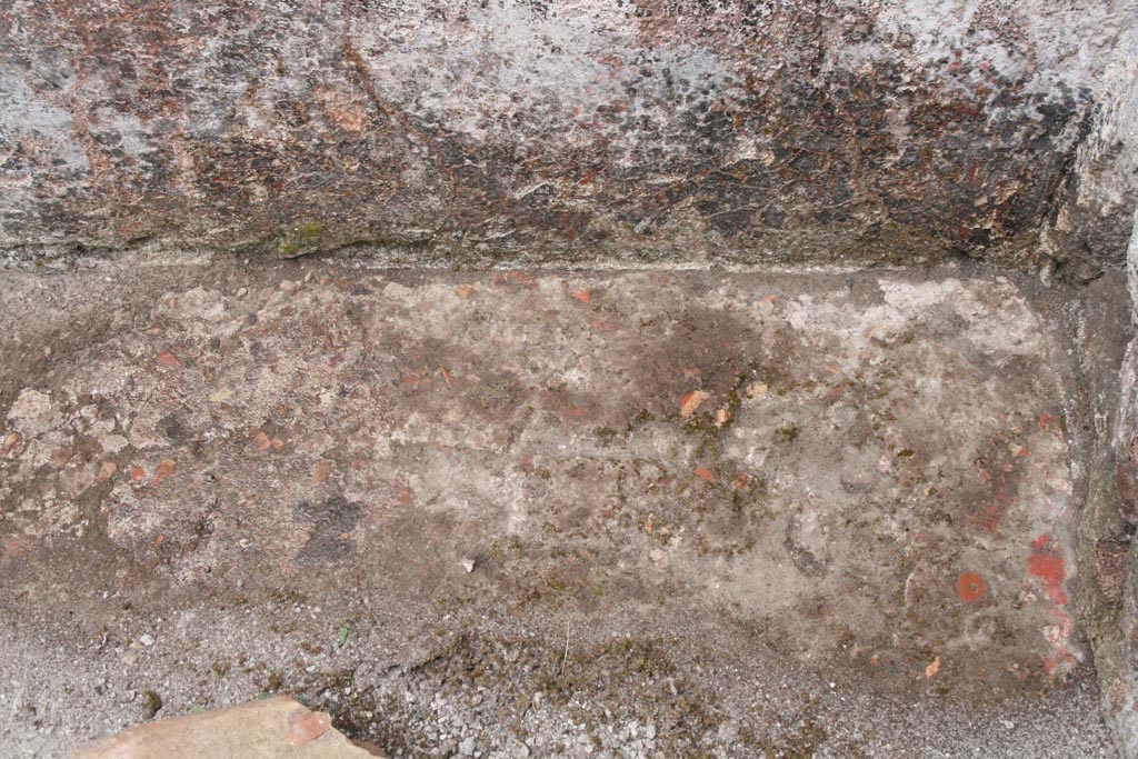 V.1.7 Pompeii. c.2005-7. Room 16, flooring in north-west corner. Photo by Thomas Staub.
“The floor in this room consists of a simple cocciopesto pavement without further decorations.
In the north-west corner, some remains of the red paint, which covered the floor, are preserved.”
Photo and words courtesy of the Swedish Pompeii Project.