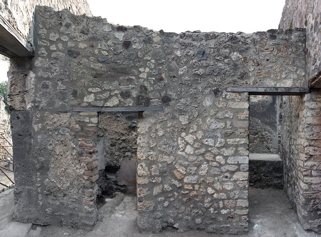V.1.11 Pompeii. c.2005-7?
Room “w”, east wall with doorway to latrine (“z”), on left, and to kitchen (“t”) on right.
Photo by Hans Thorwid.
Photo courtesy of The Swedish Pompeii Project.
