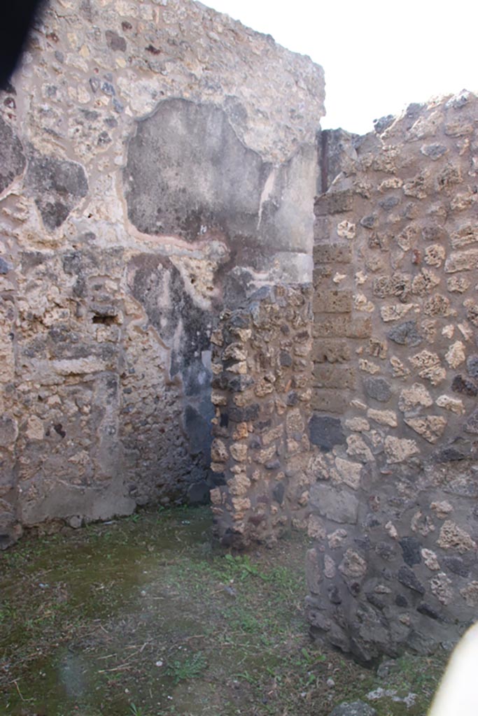 V.1.11 Pompeii. October 2023.
Looking south-west from entrance doorway, towards doorway under stairs to upper floor.
At the rear is the corridor, leading west. Photo courtesy of Klaus Heese.