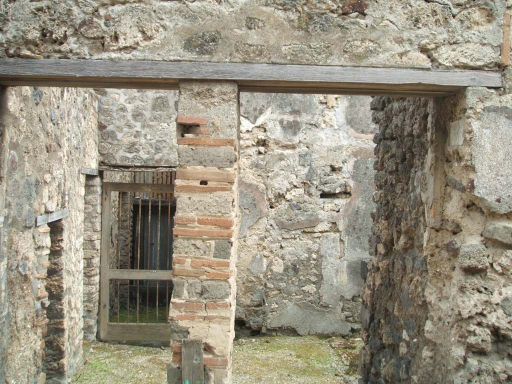 V.1.11 Pompeii, on left. May 2005. V.1.12, steps to upper floor, on right.