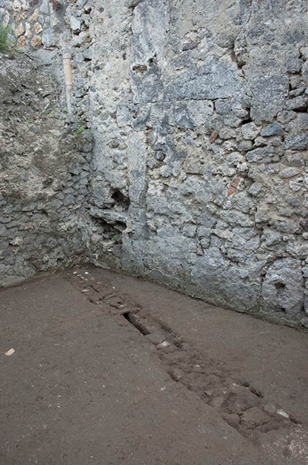 V.1.15 Pompeii. c.2012. Room “f”.
“Looking across flooring towards south-east corner, showing how conduit probably meets up with the vertical terracotta pipe embedded in the south wall.” Photo by Hans Thorwid.
Photo and words courtesy of the Swedish Pompeii Project.