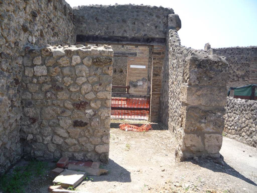 V.1.15 Pompeii. July 2008. South-west corner of atrium, with doorway to V.1.16, centre, and entrance corridor, on right. Photo courtesy of Jared Benton.