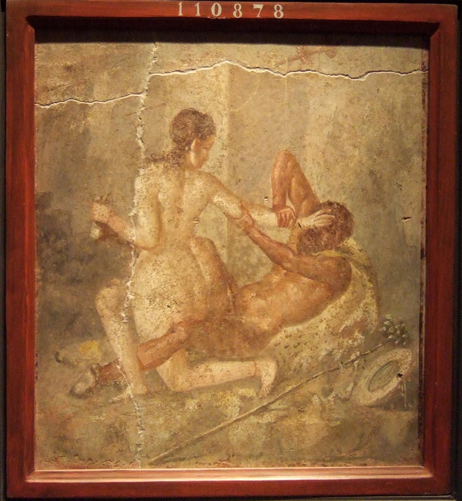 V.1.18 Pompeii. Wall painting of a lying down Satyr and a Bacchante trying to free herself from him, found on the north wall of Room “l” (L).
Now in Naples Archaeological Museum. Inventory number 110878.