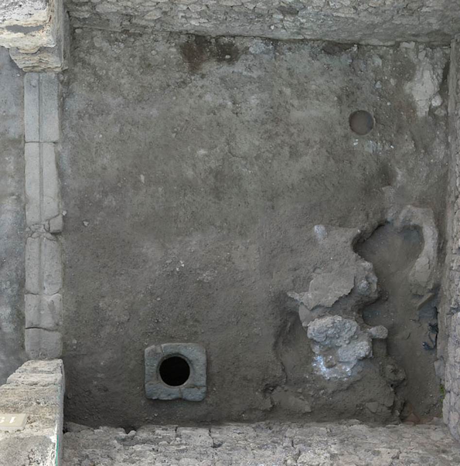 V.1.19 Pompeii. c.2005-2008. Looking down onto flooring with cistern mouth near south wall.
Photo by Hans Thorwid.
According to Boman –
“The floor has collapsed in the SE corner, though the reason is not known: presumably a cistern or pozzo nero that has collapsed — the structure in the SE corner has not been investigated.
In the centre eastern area of the room a pozzo nero partly filled in was excavated - the material gave that the taberna could have been used as a fullers.”
Photo and words courtesy of The Swedish Pompeii Project.