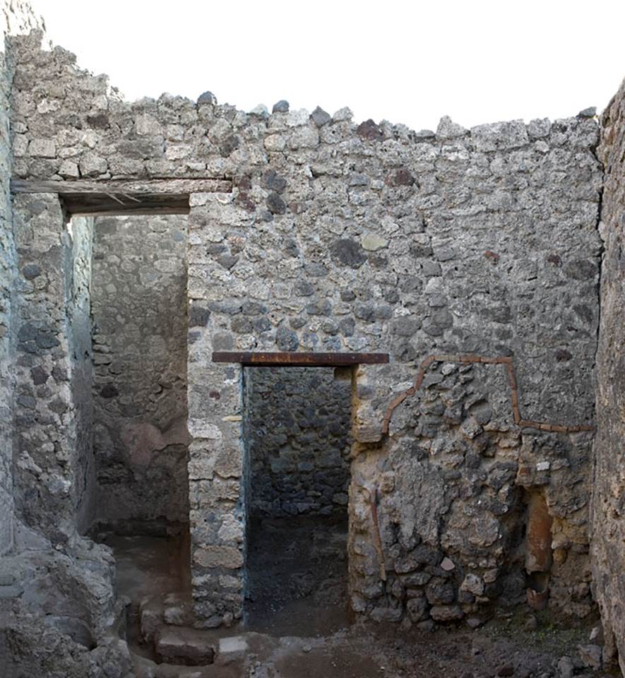 V.1.20 Pompeii. Pre-2008. Room “d”.
East wall of kitchen. Photo by Hans Thorwid.
Photo courtesy of The Swedish Pompeii Project.
The tall doorway, possibly into a light-well, and doorway into rear room in south-east corner.