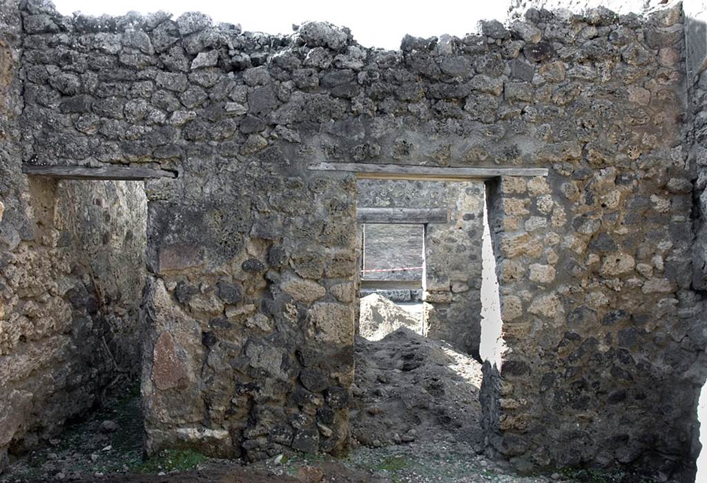 V.1.20 Pompeii. Pre 2008. Room “d”. Photo by Hans Thorwid.
West wall of kitchen, with doorway to corridor, on left, and into rear room of shop-room, on right.
Photo courtesy of The Swedish Pompeii Project.