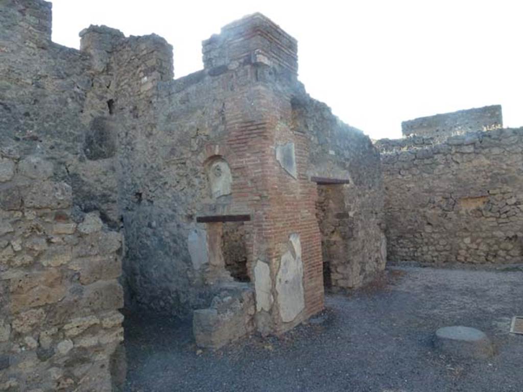 V.2.1 Pompeii. June 2012. Looking north along west side of entrance area. Photo courtesy of Michael Binns.
According to BdI -
“This house had two shops towards its south side; the one (no.2, numbered “f” on BdI plan) with a rear room “g”.
The other shop at no.1, with two side rooms (numbered “b” and “c”, in this last a fragment of amphora with the word CALVENT….. was found). 
A secondary exit was excavated in room “d” (numbered as V.2.a), near to which was a latrine “e”.
Under “a” was a cellar accessible by a small opening almost in the middle of the room.”
See Mau in BdI, 1885, (p.158).
