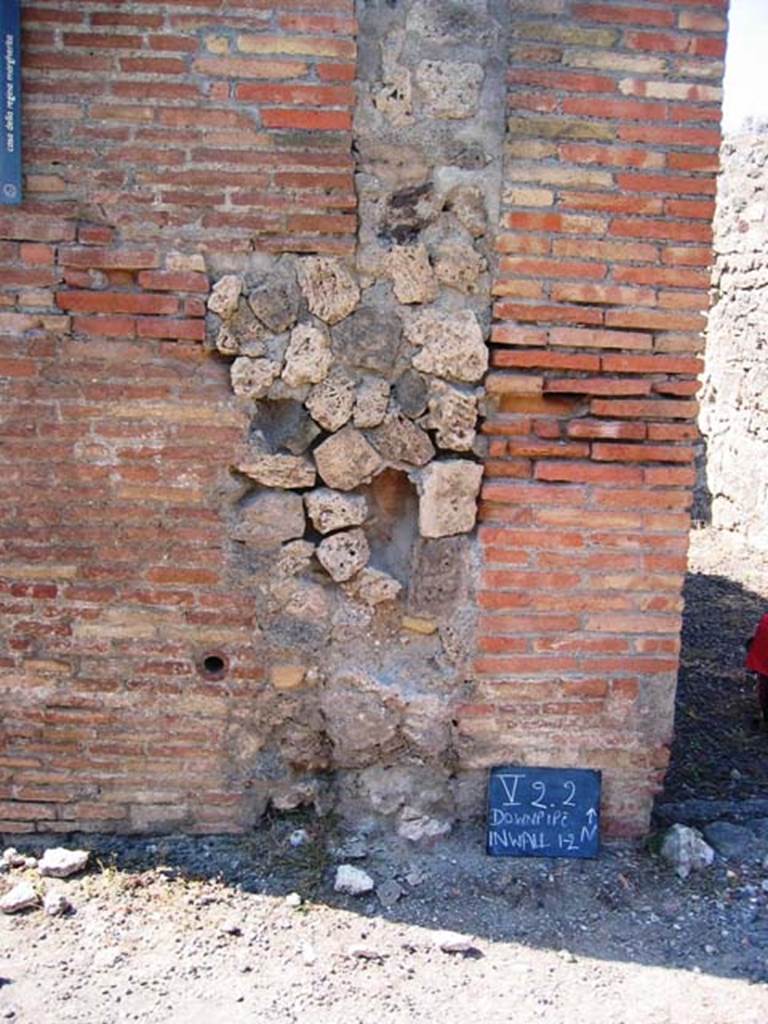 V.2.2 Pompeii. July 2008. Downpipe in exterior wall, on west side of entrance doorway.
Photo courtesy of Barry Hobson.