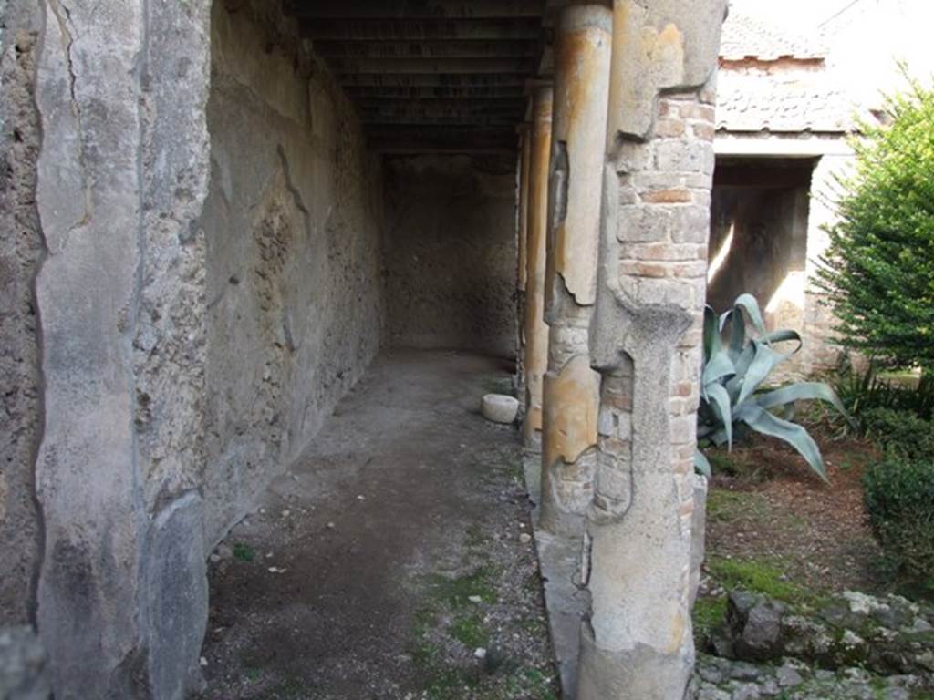 V.2.4 Pompeii. December 2007. Looking north along west side of peristyle.
According to Jashemski –
The peristyle garden at the rear of the tablinum of this caupona (excavated 1884-5) had a portico that had undergone various changes. It was supported by columns and pillars on part of the south, west and north sides.
The low masonry wall near the edge of the garden which outlined its limits on these sides, had a planting area on the south side in the top of the wall. There was a gutter, wider on the south side, just inside this wall.
Graffiti written on the portico just outside the triclinium by the fuller L. Quintilius Crescens give a vivid picture of a banquet held by the fullers in this caupona, etc. (see CIL IV numbers on a photo below).
There is a marble statue base in the garden today. The arched niche in the west wall may have been a lararium.
There is a lararium painting in the south-east corner of the garden.
See Jashemski, W. F., 1993. The Gardens of Pompeii, Volume II: Appendices. New York: Caratzas. (p.111).