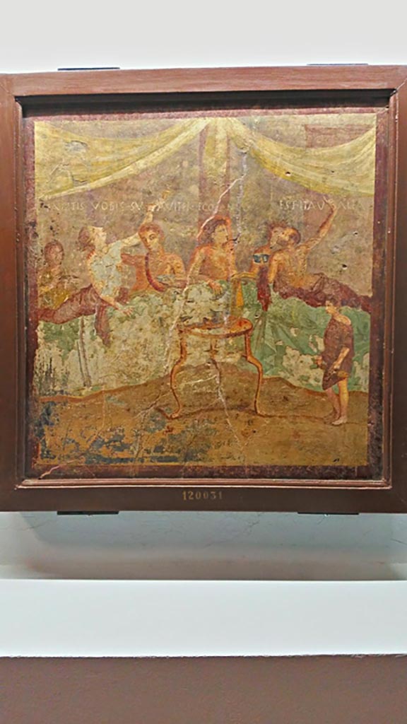 V.2.4 Pompeii. Room 15, painting of banqueting scene from north wall of triclinium.
On display in Naples Archaeological Museum, inv. 120031.
Photo courtesy of Giuseppe Ciaramella, June 2017.
