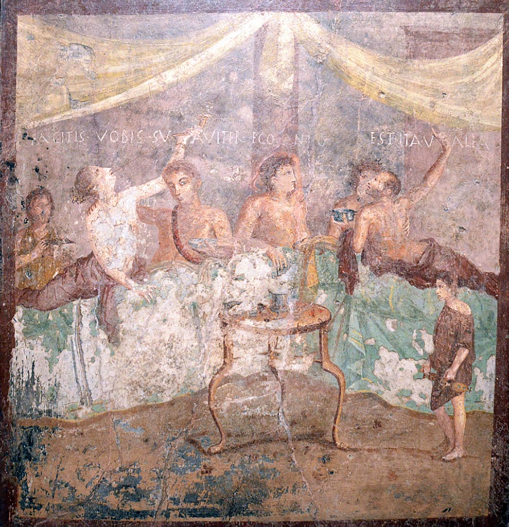 V.2.4 Pompeii. Room 15, painting of banqueting scene from north wall of triclinium showing the Commencement.
The guests are reclining at table and a boy brings in dishes.
Now in Naples Archaeological Museum. Inventory number 120031. Photo courtesy of Giuseppe Ciaramella taken December 2019.
