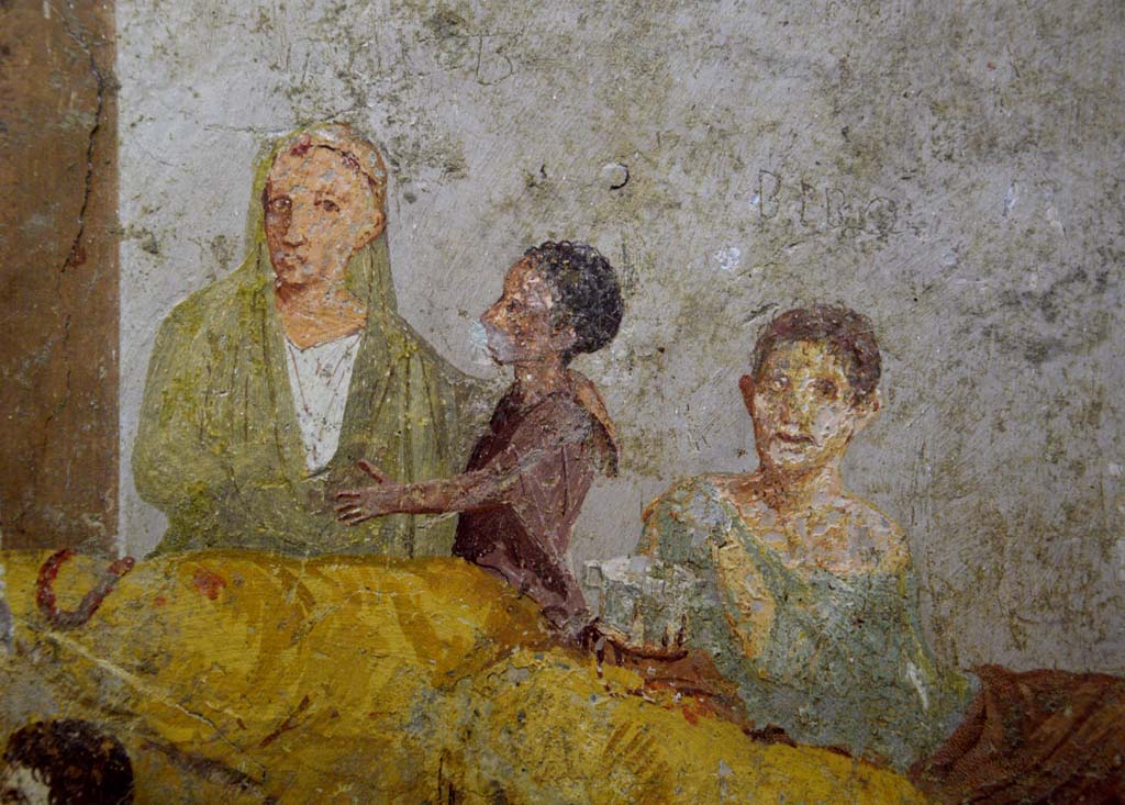 V.2.4 Pompeii. June 2017.
Room 15, detail from painting of banqueting scene from east wall of triclinium. Photo courtesy of Johannes Eber.