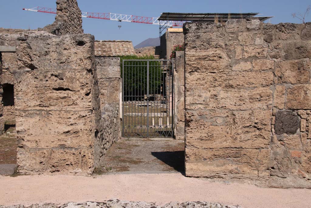 V.2.4, Pompeii. September 2021. Looking north on Via di Nola towards entrance doorway. Photo courtesy of Klaus Heese.
