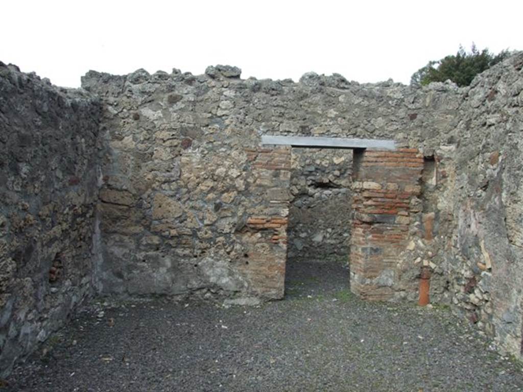 V.2.8 Pompeii. March 2009. North wall of shop, with doorway to rear room.