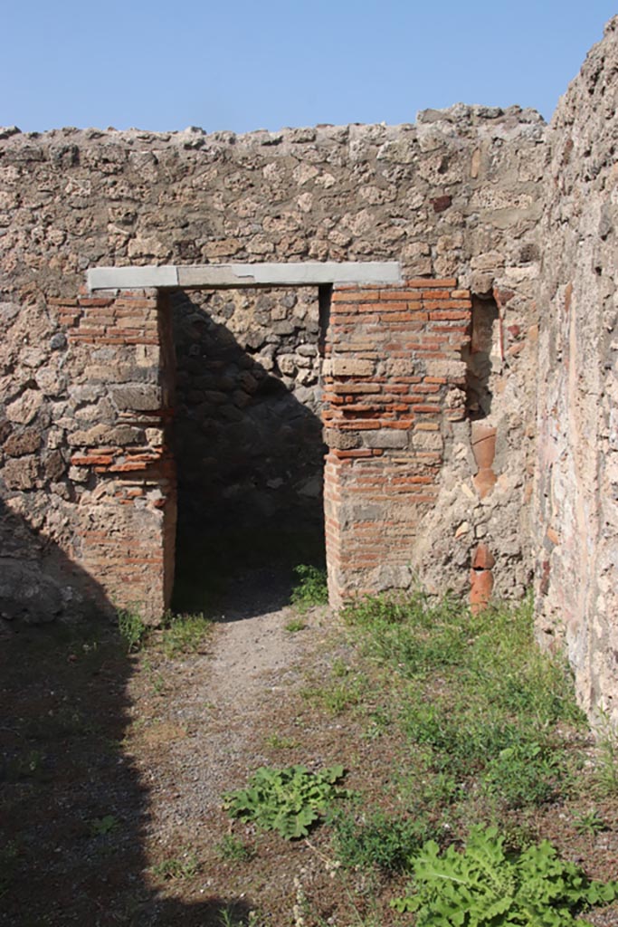 V.2.8 Pompeii. October 2023.
Looking towards doorway in north wall of shop-room. Photo courtesy of Klaus Heese.