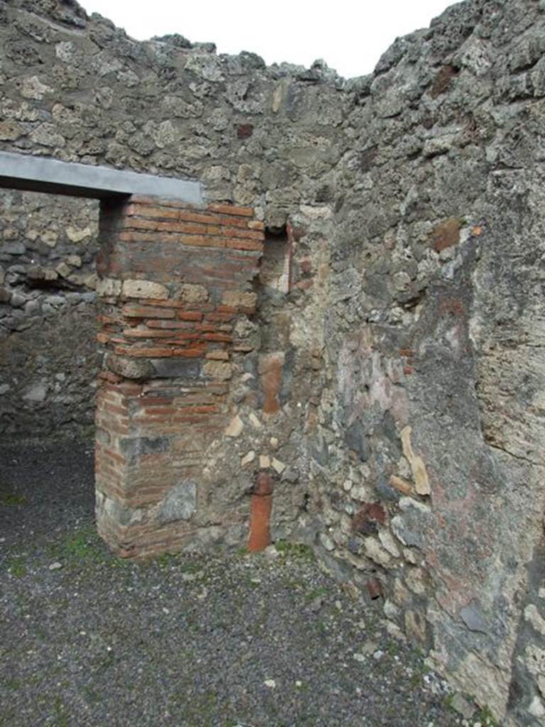 V.2.8 Pompeii. March 2009. On the rear east wall were the stairs to upper floor, and underneath was the Latrine. In the north east corner is a downpipe from upstairs.