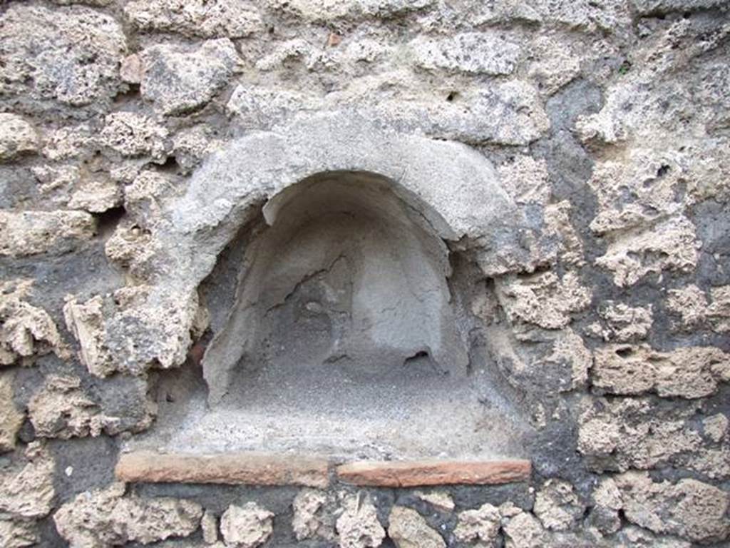 V.2.9 Pompeii. March 2009. Small niche Lararium on west wall. According to Boyce, this arched niche was described by Sogliano as la nicchietta dei Penati, in Not.Scavi, 1896, 437.
See Boyce G. K., 1937. Corpus of the Lararia of Pompeii. Rome: MAAR 14. (p. 34).