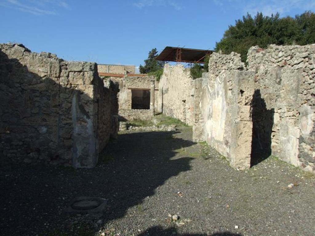 V.2.10 Pompeii. December 2007. Looking north towards room 3, tablinum.
According to NdS, opposite to the entrance corridor was the tablinum, with the doorframes covered in fluted white plaster.
On the east wall was the painting of Hippolytus and Phaedra, described in NdS and BdI.
See Notizie degli Scavi di Antichità, 1891, (p.268).
According to BdI, the tablinum was painted in the “style of the candelabra” but was only preserved on the right (east) wall. In the middle of the wall between two thin green candelabra a white panel was left (1.50 high x 0.91 length). It showed Hippolytus and Phaedra, occupying nearly the entire width but was not higher than 0.80.
On the same wall, on the upper part to the left, (0.54 high x 0.42 length) but badly preserved was a painting with doors, in the usual manner. On the left, was a clothed woman playing the lyre which she held on her left side.
To the right of the centre, another fully-clothed woman (looking left) leaning against a column, raises her left hand, in which she holds an object in the guise of a roll(?) (un rotolo) and whose other extremity, seems to touch the chin. Further to the right up to the border, but further back, stands a building, open in front and back, in which you recognize a figure whose details are not distinguished: it seems, however, that she is naked and that she is putting a cloth on top of some furniture.
See Mitteilungen des Kaiserlich Deutschen Archaeologischen Instituts, Roemische Abtheilung Volume XXVI, 1890, p. 260-261).
