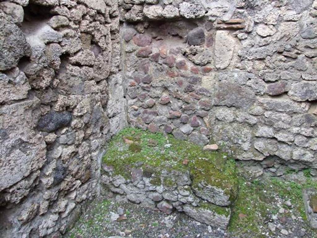 V.2.13 Pompeii. March 2009. Kitchen with hearth in north-west corner.
According to Boyce, above the hearth was a badly preserved lararium painting. The Genius was represented sacrificing at an altar. On each side stood a Lar, but only the one on the right was preserved. Further to the right a serpent approached an altar. The description was from Sogliano published in 1879. Reports in periodicals published in 1894 and 1896 mention only an altar as being visible in a painting. Today, nothing remains.
See Boyce G. K., 1937. Corpus of the Lararia of Pompeii. Rome: MAAR 14. (No. 92 on p34)
See Sogliano, A., 1879. Le pitture murali campane scoverte negli anni 1867-1879, Naples.