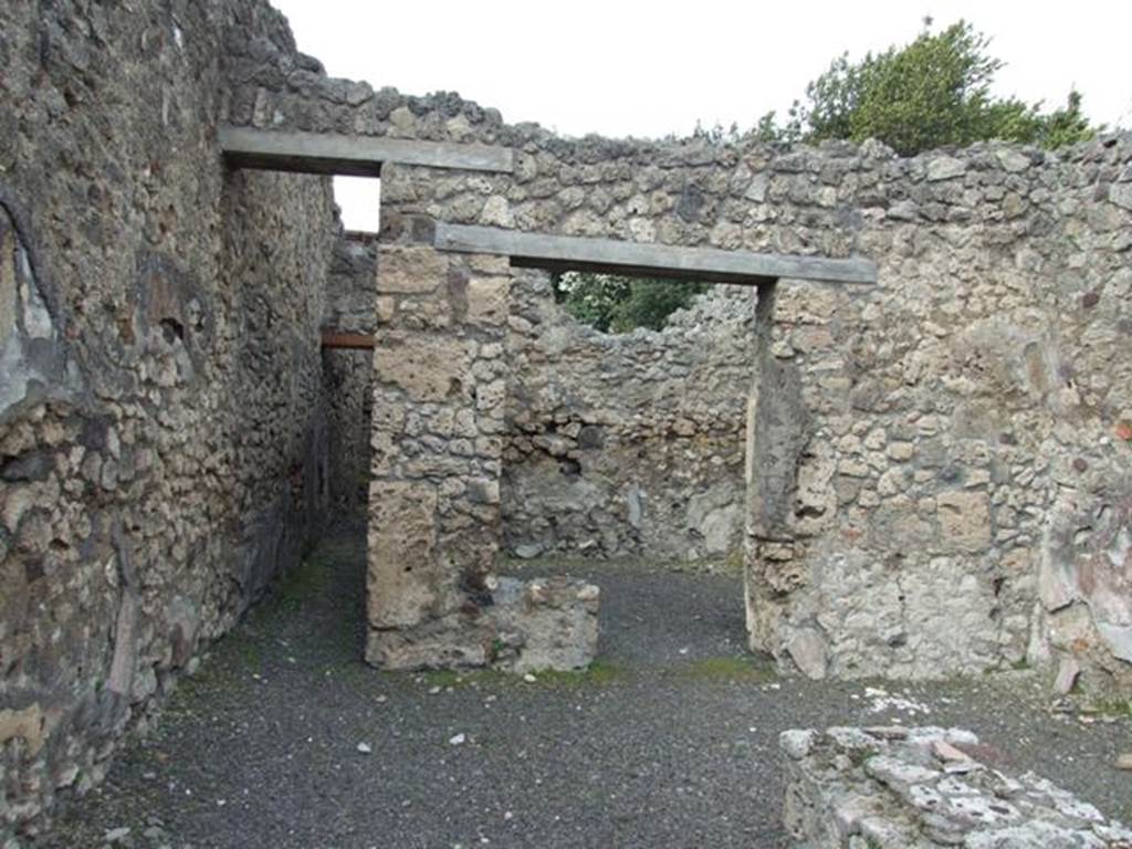 V.2.13 Pompeii, March 2009. North wall, with corridor to kitchen and latrine and doorway to rear room.
