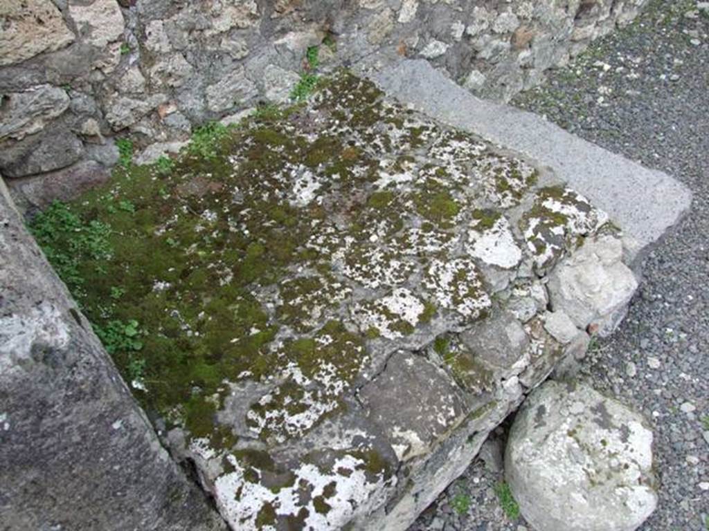 V.2.13 Pompeii. March 2009. South-west corner of thermopolium, and masonry hearth or base.
According to Boyce,
“Above the hearth in the south-west corner is a poorly preserved lararium painting: The Genius is represented sacrificing at an altar; on each side originally stood a Lar, only the one on the right being now preserved; further to the right a single serpent approaches an altar.
The above description is taken from Sogliano published in 1879; the descriptions of this house in Rom. Mitt and Not. Scavi, published fifteen and seventeen years later, mention only an altar is visible in a painting, but presumably all refer to the same shrine.”
According to NdS, this thermopolium had a sales counter and a small hearth.
On the west wall Sogliano could see the remains of a painted lararium, with a serpent sliding towards an altar on the left.
At the rear was located the room for the customers, which was bordered by a corridor to the latrine.
See Notizie degli Scavi di Antichità, 1896, (p.438)