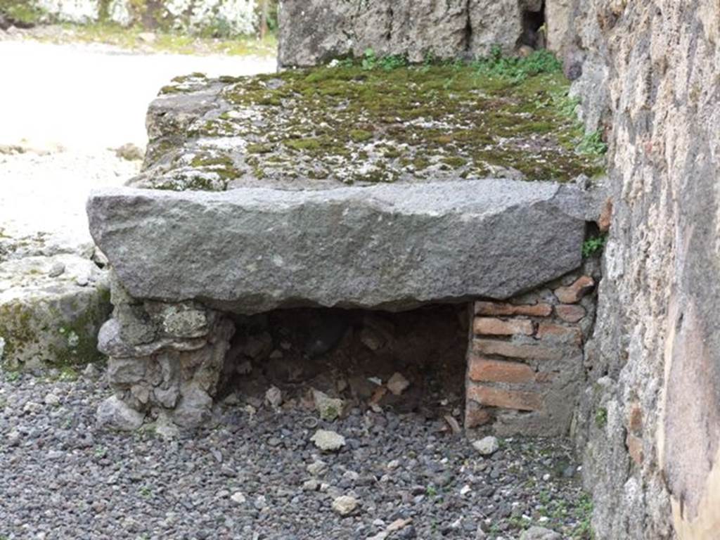 V.2.13 Pompeii. March 2009. South-west corner of thermopolium.
According to Mau, he could believe that the remains of the material to the left of the entrance were a hearth. Above this was painted the usual serpent, although only the right side was conserved. Also against the left wall were the very steep stairs to the upper rooms. Also found was a small cylindrical travertine altar, used no doubt for the sacrifices before the lararium (see V.2.14 for a note by Boyce)..
See Mau, A., 1894. Mitteilungen des Kaiserlich Deutschen Archaeologischen Instituts, Roemische Abtheilung Volume VIII. (p.49)
According to Boyce, above the hearth was a badly preserved lararium painting. The Genius was represented sacrificing at an altar. On each side stood a Lar, but only the one on the right was preserved. Further to the right a serpent approached an altar.
This description was from Sogliano published in 1879. Reports in periodicals published in 1894 and 1896 mention only an altar as being visible in a painting. Today, nothing remains.
See Boyce G. K., 1937. Corpus of the Lararia of Pompeii. Rome: MAAR 14. (No. 92 on p34)
See Sogliano, A., 1879. Le pitture murali campane scoverte negli anni 1867-1879, Naples. (p.12, no.20)
