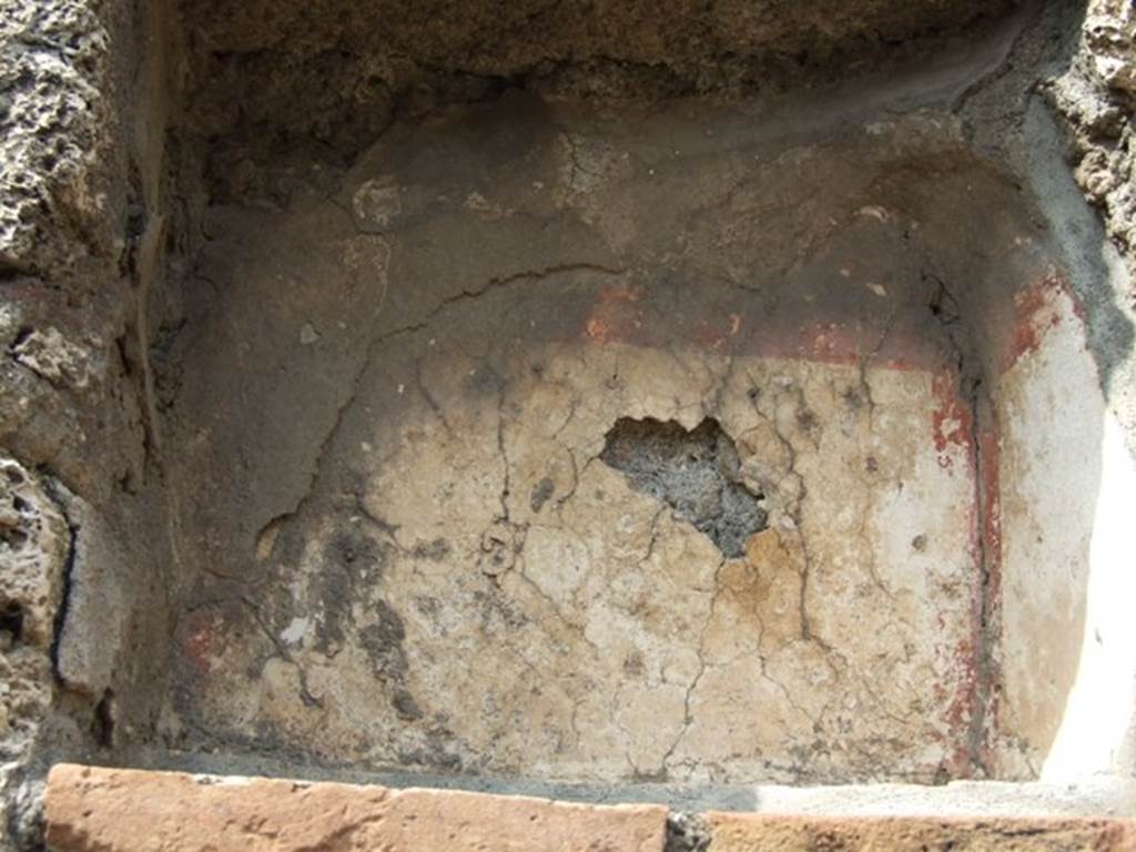 V.2.14 Pompeii. March 2009. Niche with remains of stucco, walls painted white and with red stripes around the edges.