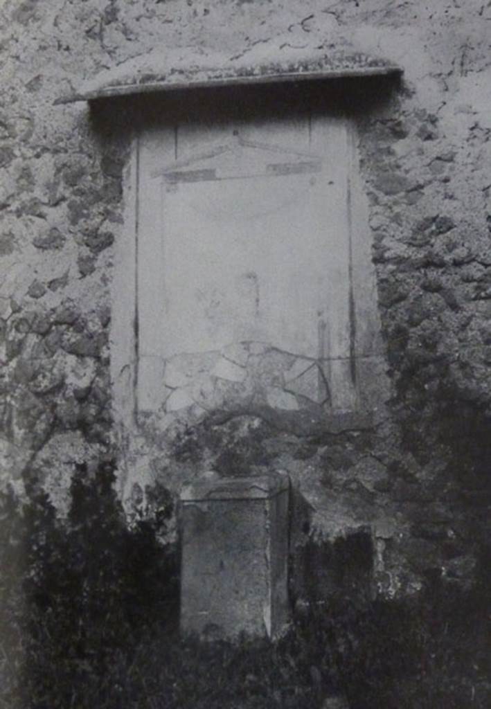 V.2.15 Pompeii. Old undated photograph. Garden 11c. North wall. Lararium.
The Notizie degli Scavi records a panel of white stucco.
On this is painted an aedicula, which Boyce says is painted in blue, yellow, dark red and green.
Within the aedicula is a painting of Giove (Jupiter) seated on a throne.
Underneath is a masonry altar covered with white plaster.
See Notizie degli Scavi di Antichità, 1894, p. 439.
See Boyce G. K., 1937. Corpus of the Lararia of Pompeii. Rome: MAAR 14. (96, p.35, Pl 39,3).