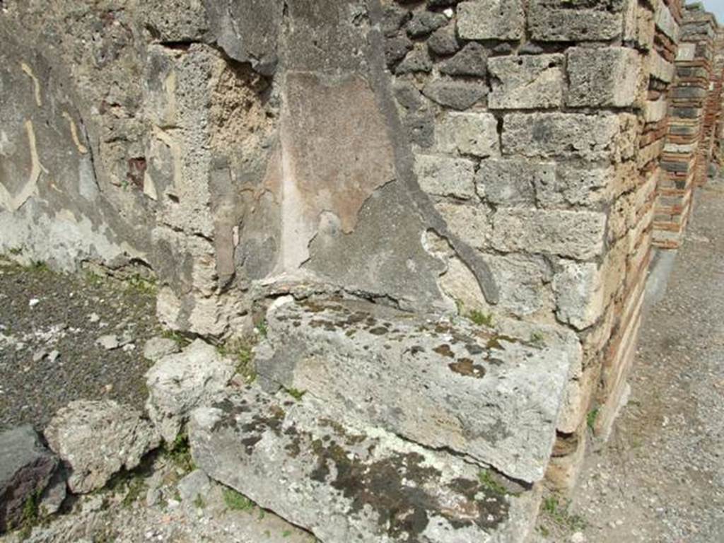 V.2.16 Pompeii. March 2009. Two stone steps on east side of entrance doorway on Via di Nola, and wall at rear with plaster.