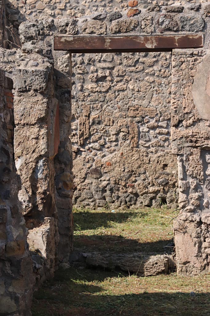 V.2.19 Pompeii. October 2022.
Looking through linking doorway in north wall of rear room, looking north to light-yard of V.2.20.
On the left is the window from the small room, to the rear of V.2.17. Photo courtesy of Klaus Heese.