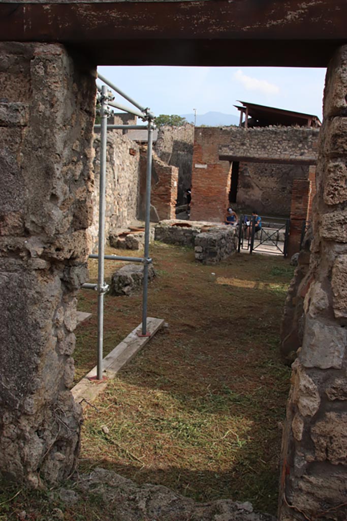 V.2.20 Pompeii. October 2022.
Looking south through doorway into rear room of V.2.19. Photo courtesy of Klaus Heese.
