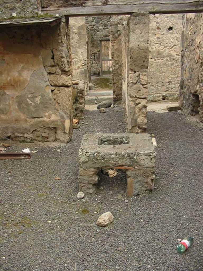 V.2.b/c Pompeii. May 2003. Room “b”. Stove in centre of room.
It was a covered in reddish stucco (with addition of brick dust), and in the centre was fitted a quadrangular lead jar with a round mouth.
Looking west towards entrance to V.2.b (on left) and V.2.c (on right).
Photo courtesy of Nicolas Monteix.