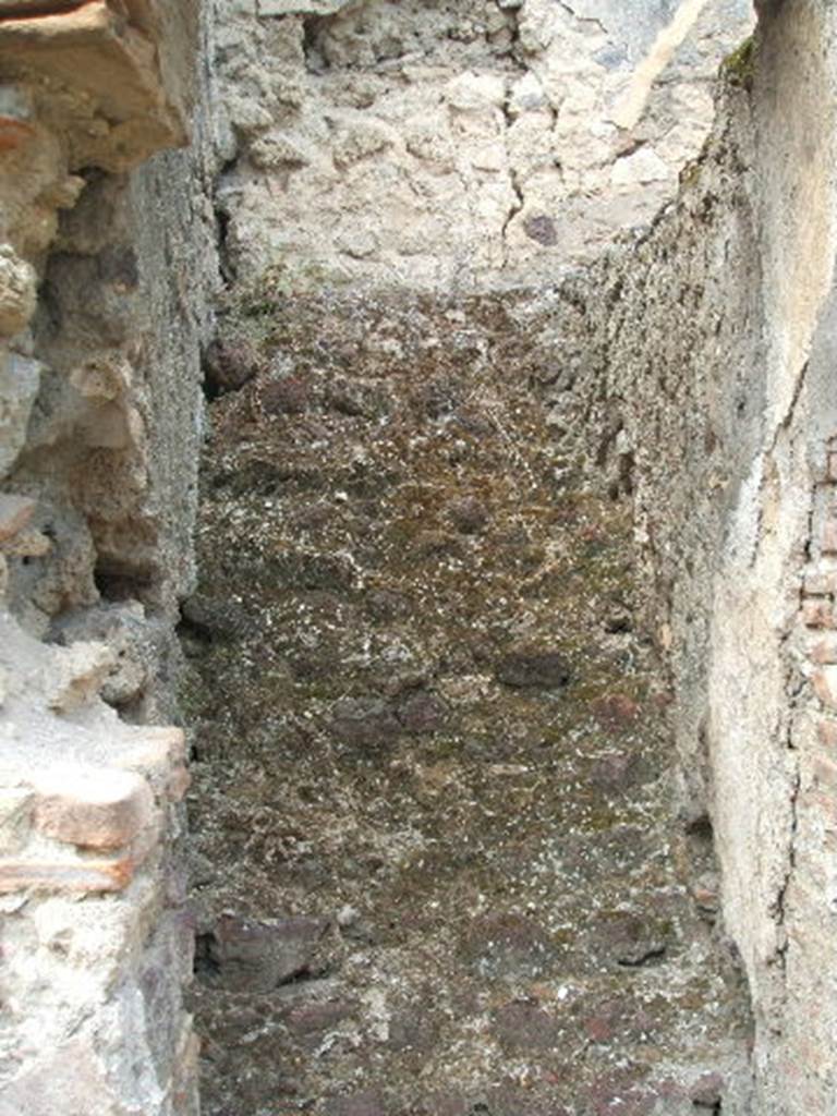 V.2.e Pompeii. May 2005. Steps to upper floor.
On January 24th 1884 there were found three great circular bronze amphitheatre trumpets (tubae), the circumference 4.12 m., and a diameter of 1.20 m. approximately. At 0.63 m. from the bell there was soldered a cylinder, which corresponded to another 0.70m. from the mouthpiece.
These were used to hold the ends of the wooden cross, which rested on the shoulder, as seen in the figure of the gladiator who plays a similar trumpet, in one of the paintings now destroyed the podium of the amphitheatre.
Near the mouth was a large bronze wire, in two trumpets bronze and in one iron, which was fixed to the wooden cross piece. They were broken in some parts when discovered, but with easy restoration would be put back in pristine condition.
See Notizie degli Scavi di Antichità, 1884, p. 52-3.