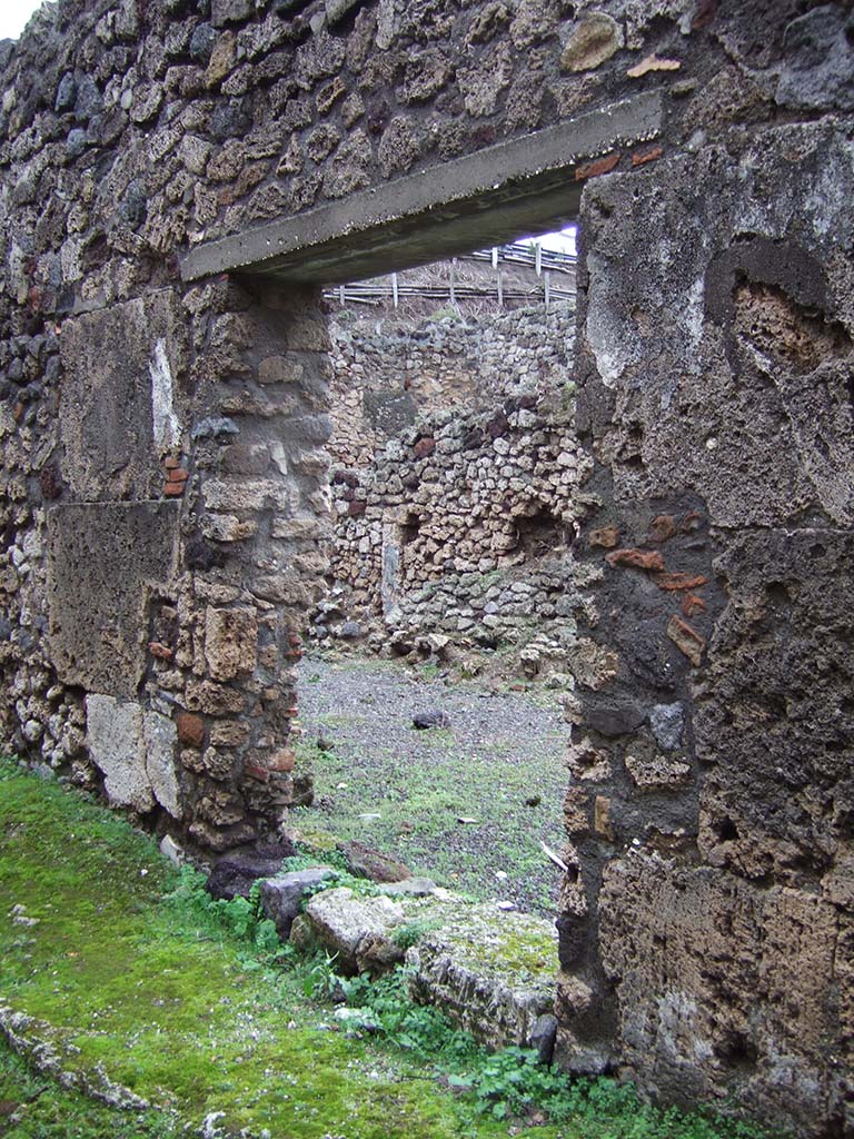 V.2.f, Pompeii. December 2005. Looking north-east through entrance doorway, from vicolo. 
According to Della Corte, graffiti were found near the entrance.
See Della Corte, M., 1965. Case ed Abitanti di Pompei. Napoli: Fausto Fiorentino. (p.108)
According to Epigraphik-Datenbank Clauss/Slaby (See www.manfredclauss.de), they read:

Cn(aeum) Helvium Sabinum aed(ilem) Crescens rog(at)    [CIL IV 3450]

Musa    [CIL IV 4268]  -  (found to the right of the entrance)
