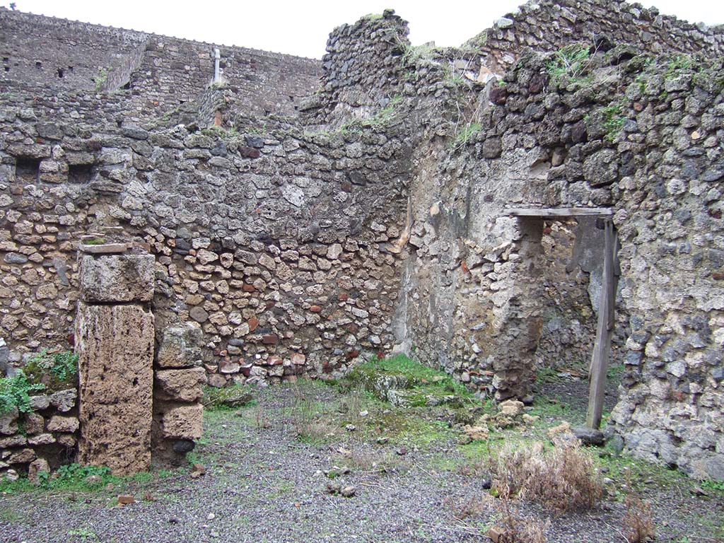 V.2.f, Pompeii. December 2005. Looking south-east across atrium. On the left would have been a cubiculum.
In the centre can be seen a room with remains of three masonry steps to an upper room above the cubiculum, and doorway to a small courtyard.
According to NdS, on the black dado of the room with the stairs was a graffito – MID/
See Notizie degli Scavi di Antichità, 1896, (p.436).
See Mau in Bullettino dell’Instituto di Corrispondenza Archeologica (DAIR), VIII, 1893, (p.7-9)
According to Jashemski, a terracotta dolium and several amphorae were found in the courtyard.
See Jashemski, W. F., 1993. The Gardens of Pompeii, Volume II: Appendices. New York: Caratzas, (p.112)