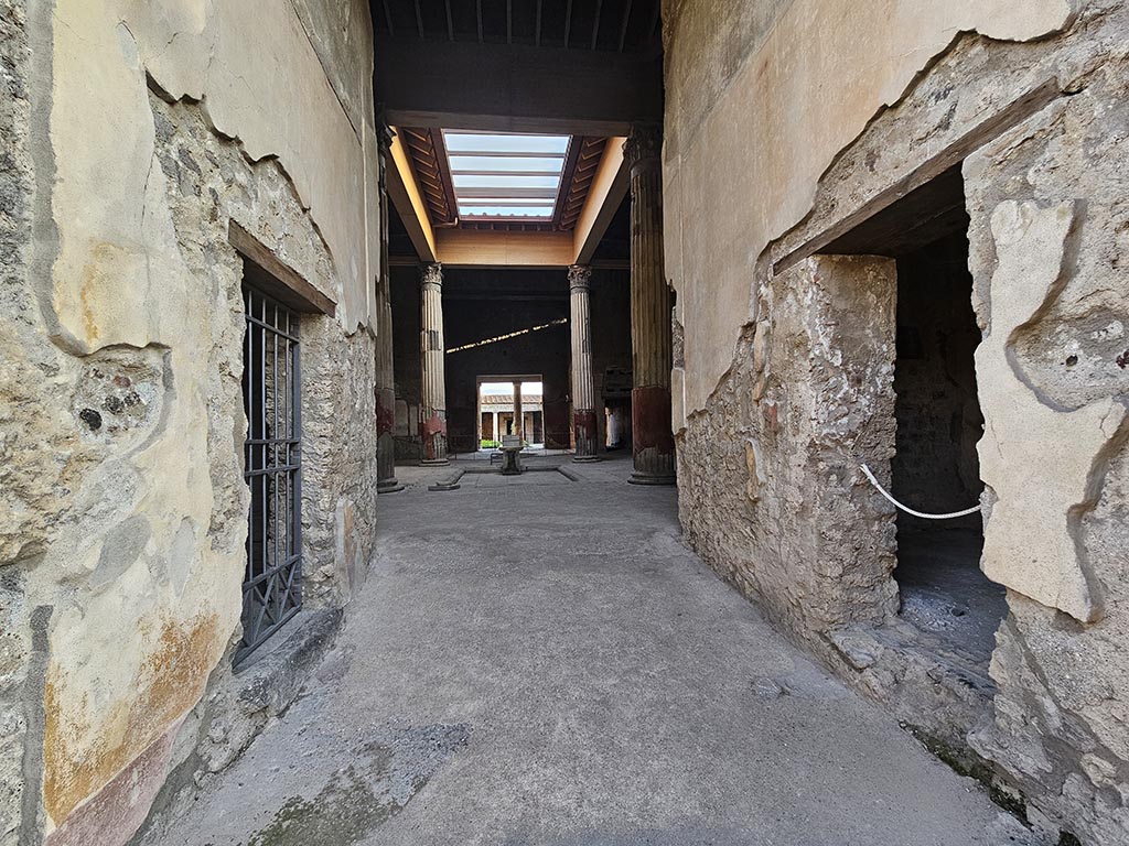 V.2.i Pompeii. November 2024. 
Looking south along entrance corridor/fauces towards atrium with compluvium. Photo courtesy of Annette Haug.
