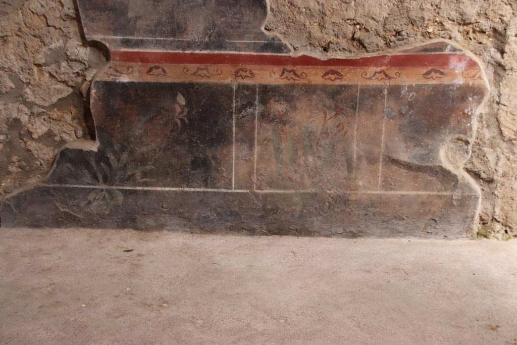 V.2.i Pompeii. October 2023.
Room 1, east wall of atrium, painted zoccolo between room 3 and stone staircase. Photo courtesy of Klaus Heese.