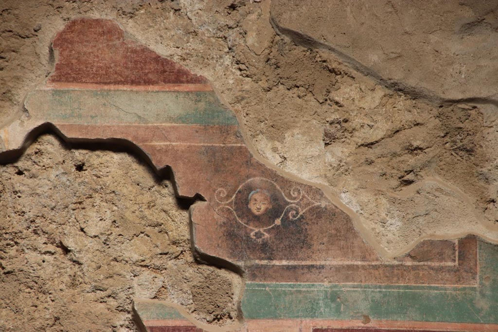 V.2.i Pompeii. October 2023.
Room 1, upper east wall on south side of doorway to room 4, detail of fragment of painted panel. Photo courtesy of Klaus Heese.
