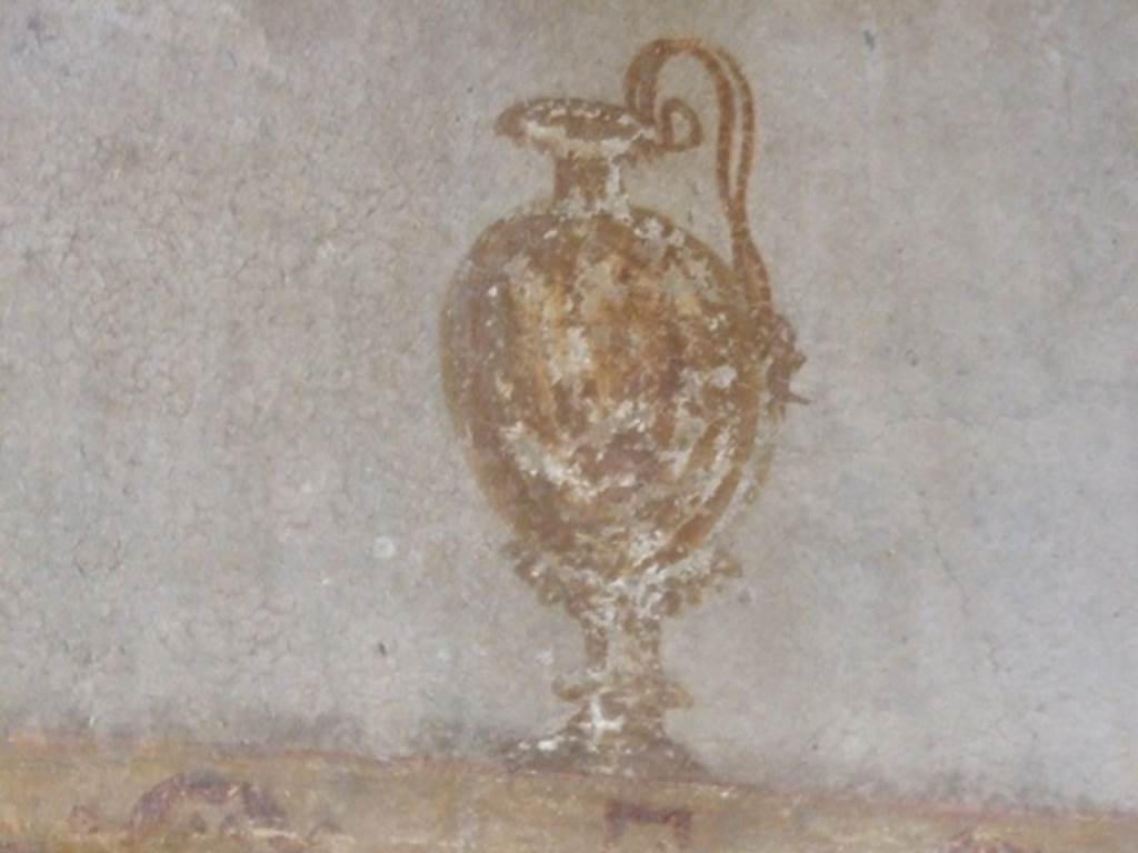 V.2.i Pompeii. December 2007. Room 10, detail of west wall painting of jug on white background above the red middle zone.
