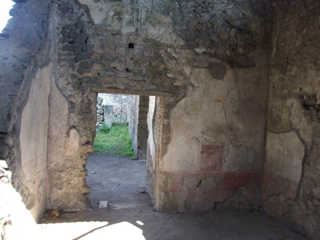 V.3.4 Pompeii. March 2009. Triclinium, east wall, with door to anteroom. According to Sogliano, found on the east wall in the area between the cornice and the vault, on a white background, were arabesques, in the centre of which was a flying golden eagle. See Notizie degli Scavi di Antichità, 1905, (p.213).