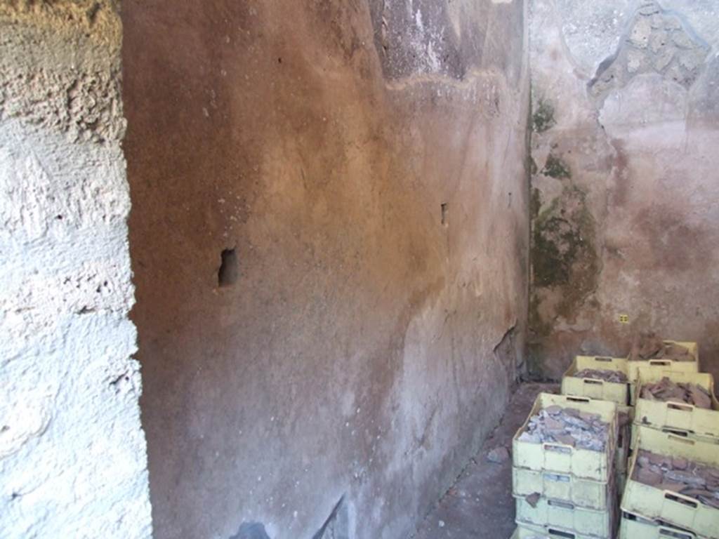V.3.4 Pompeii. March 2009. Small room, East wall with remains of shelving supports.