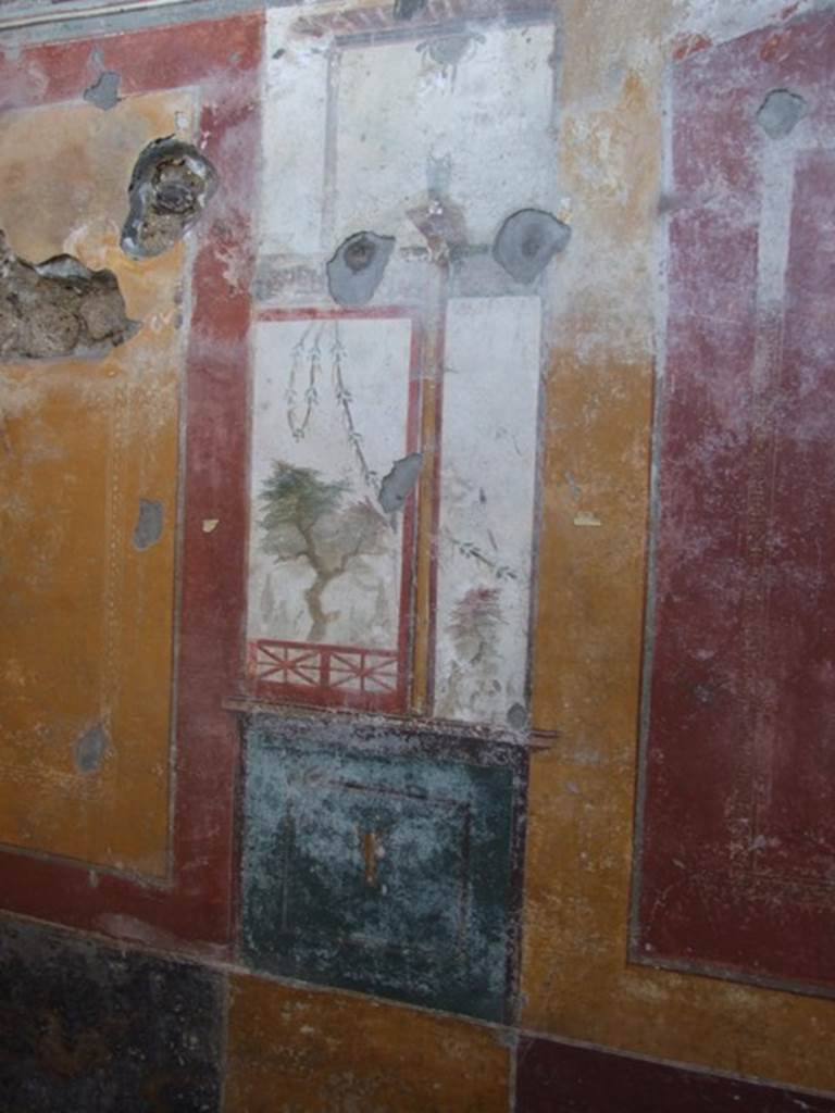 V.3.6 Pompeii. March 2009. Triclinium. West wall, detail of painted panel, with Tree and Garland.