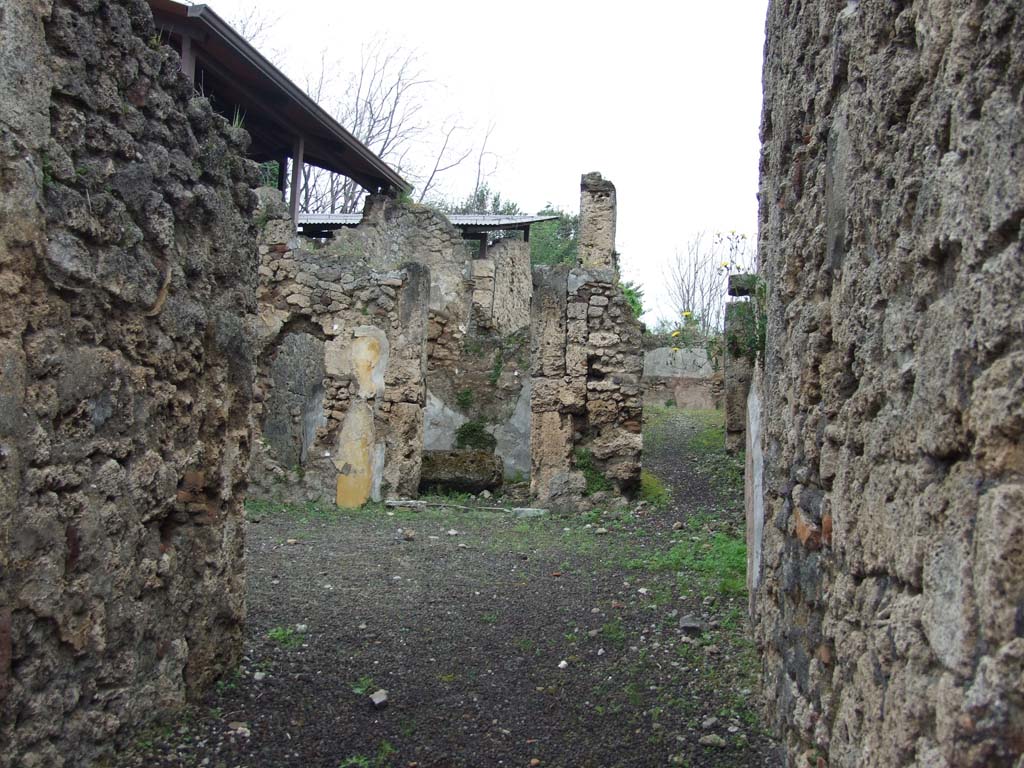 V.3.7 Pompeii. May 2010.
Looking north from entrance fauces across atrium to doorway to triclinium and andron or corridor leading to garden.