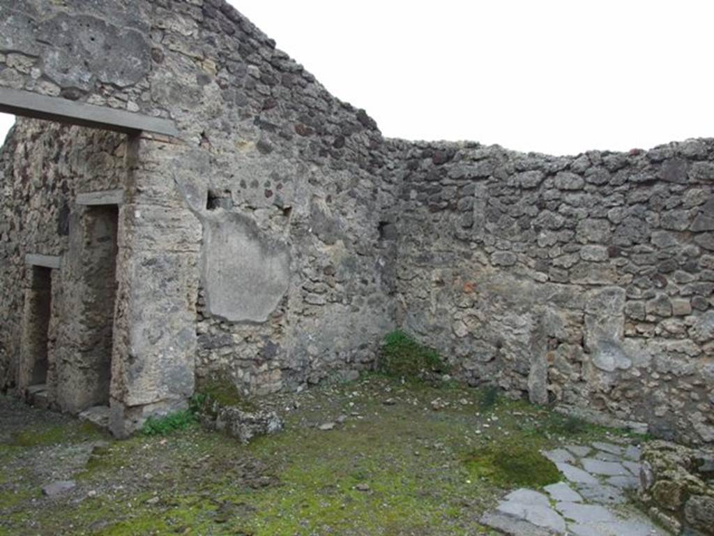 V.3.8 Pompeii. December 2007. South west corner of the Atrium bakery area. Against the south wall are the masonry remains of two possible table supports.